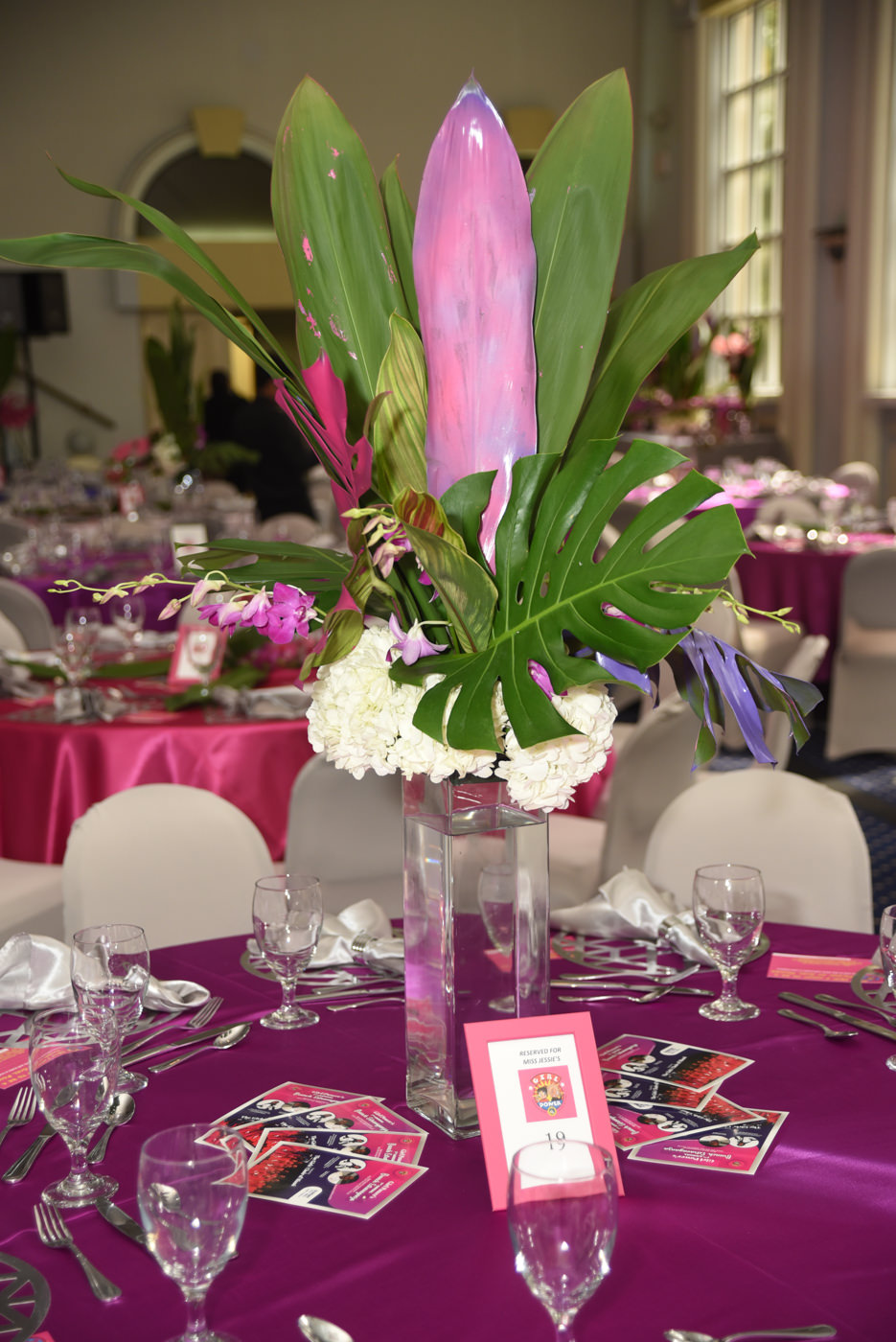 Girl Power Rocks event with pink and green floral arrangement on pink table with white chairs eccessories by ellen www.eccessoriesbyellen.com