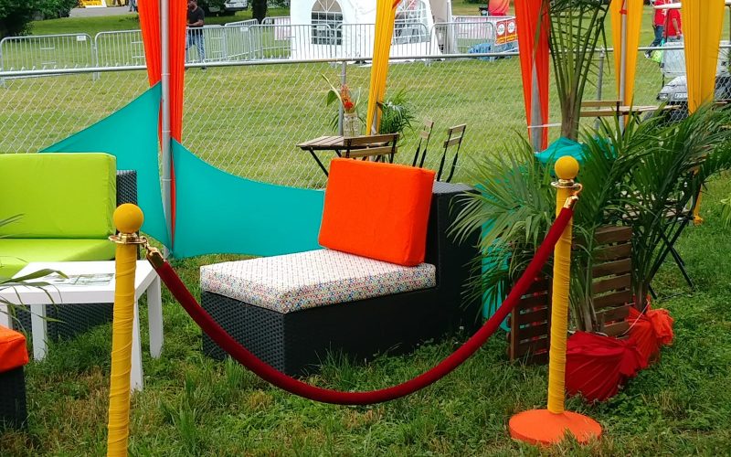 Jamaican Jerk Festival event with green and orange couches - eccessories by Ellen www.eccessoriesbyellen.com